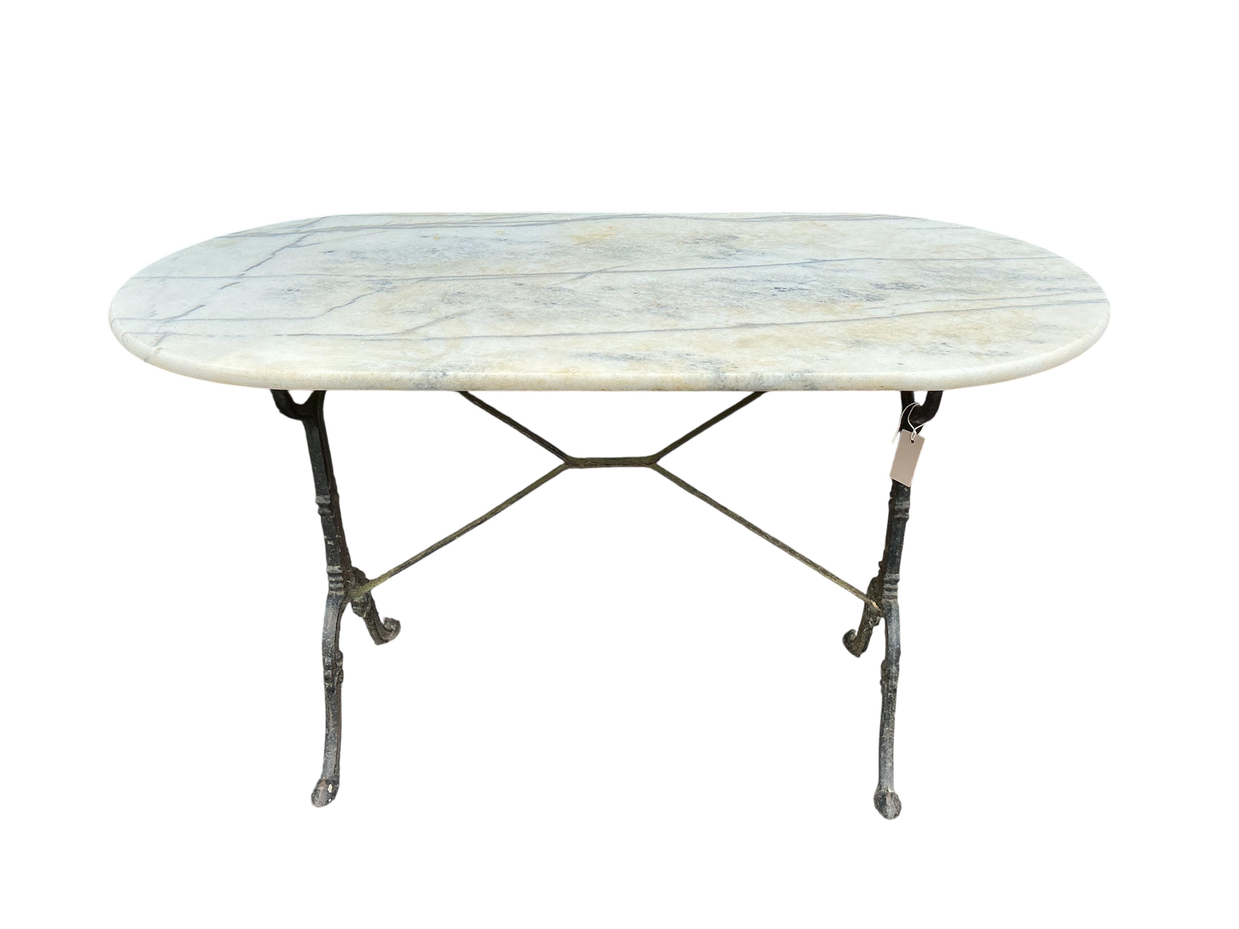 An oval reconstituted marble and cast iron garden table, width 120cm, depth 60cm, height 71cm